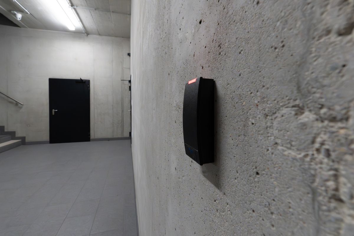Electronic card reader mounted beside a secure entry door