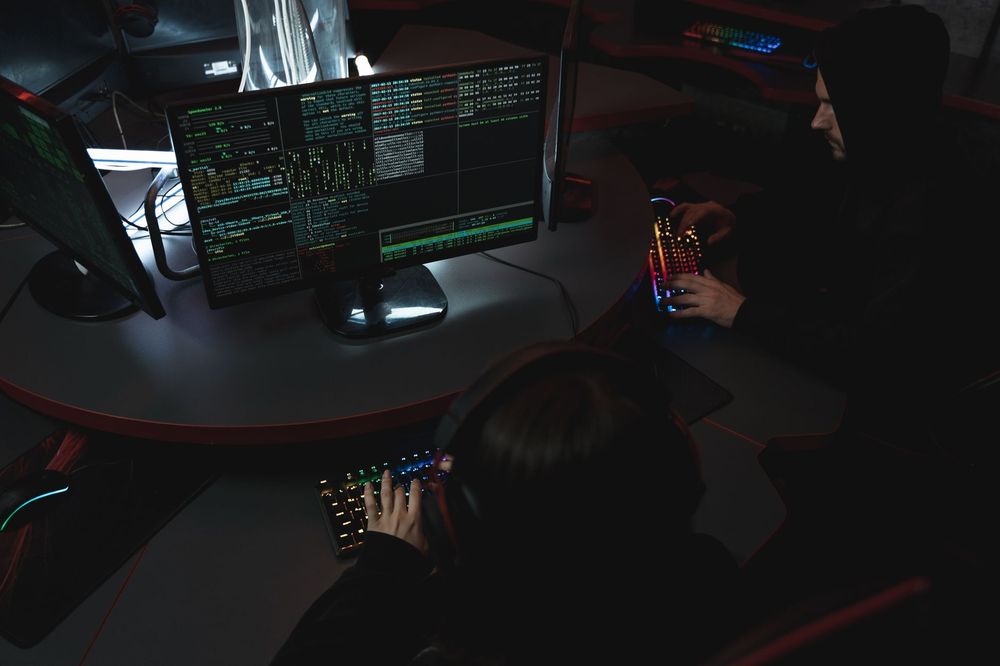 Dark monitors showing a security breach alert in a security operations center
