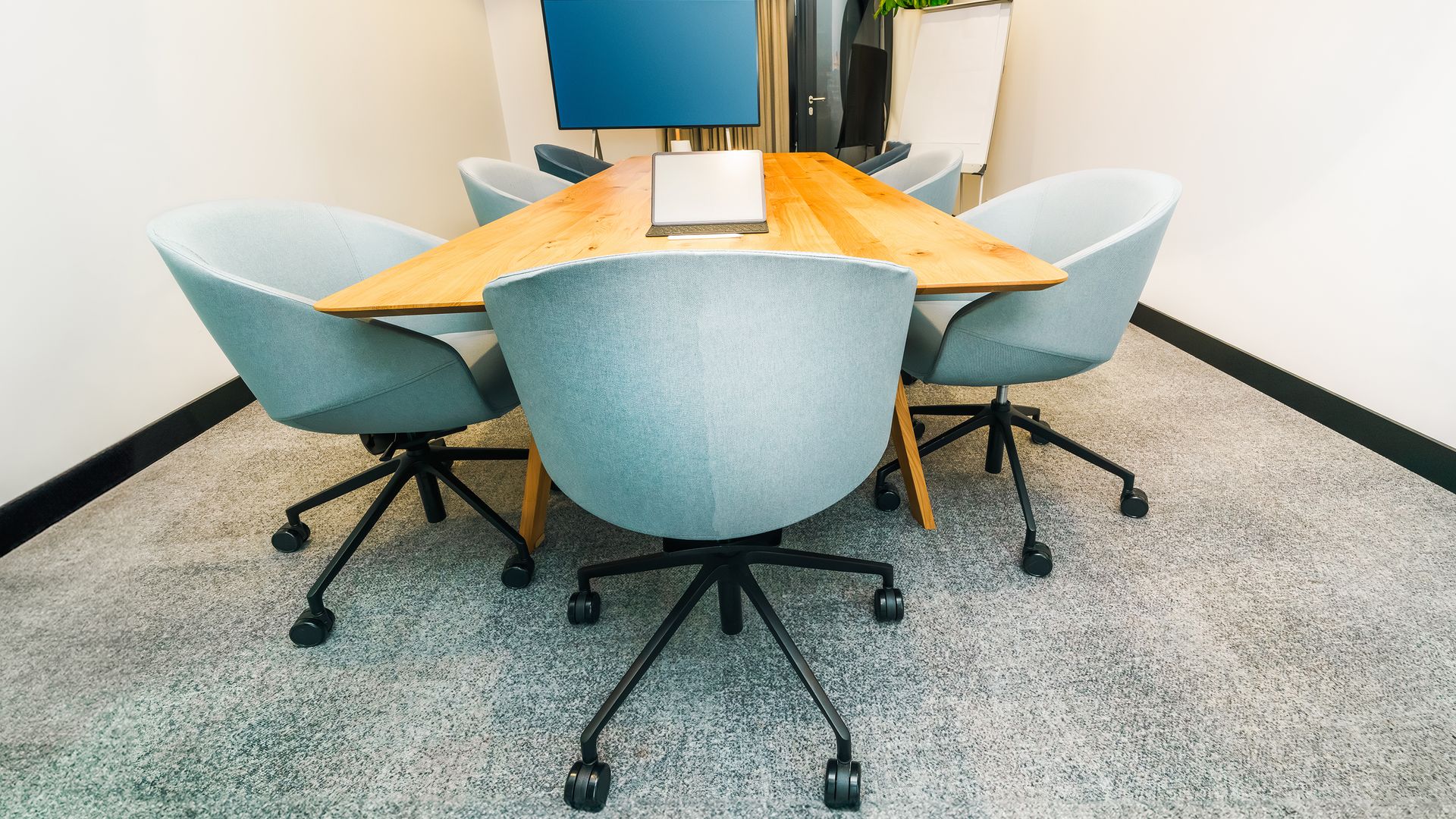Conference room with a wall-mounted display and meeting table