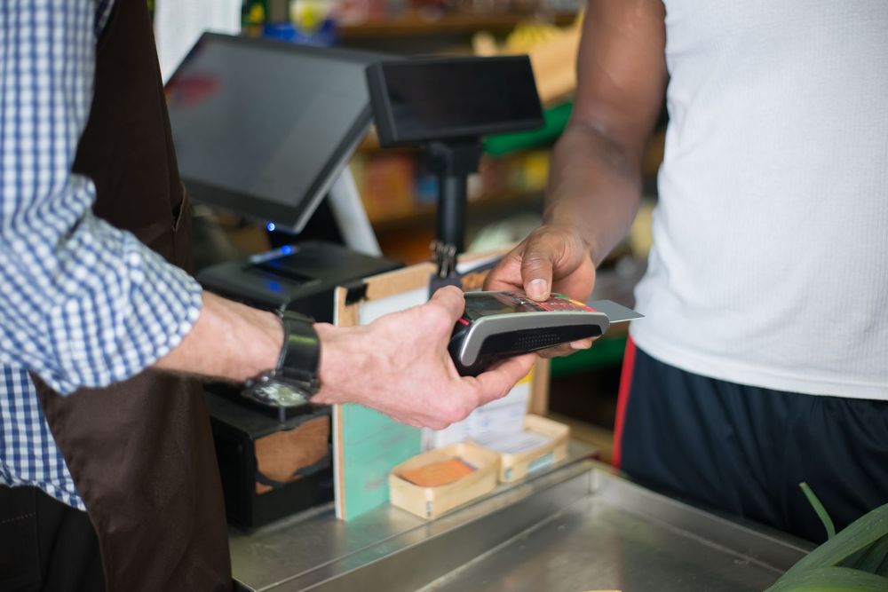 Card payment terminal at a small retail checkout counter
