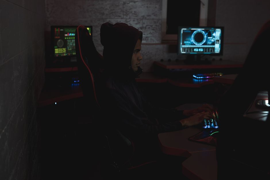 Security analyst monitoring threats on multiple screens in a 24/7 security operations center