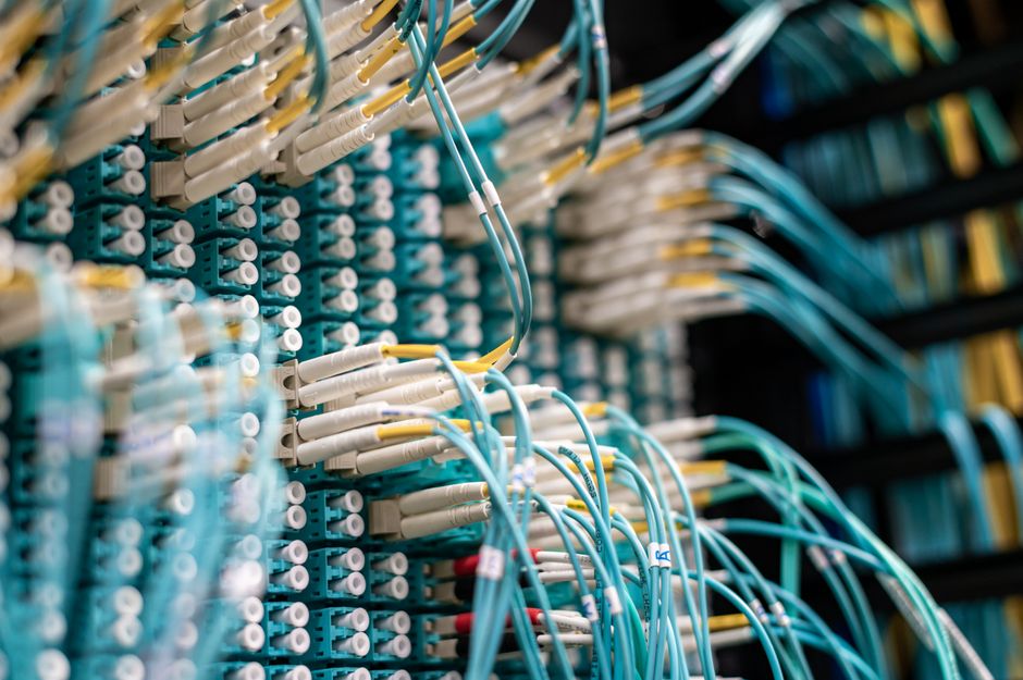 Close-up of structured fiber cabling in a network rack